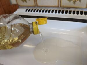 Pouring Sunflower oil into a pan